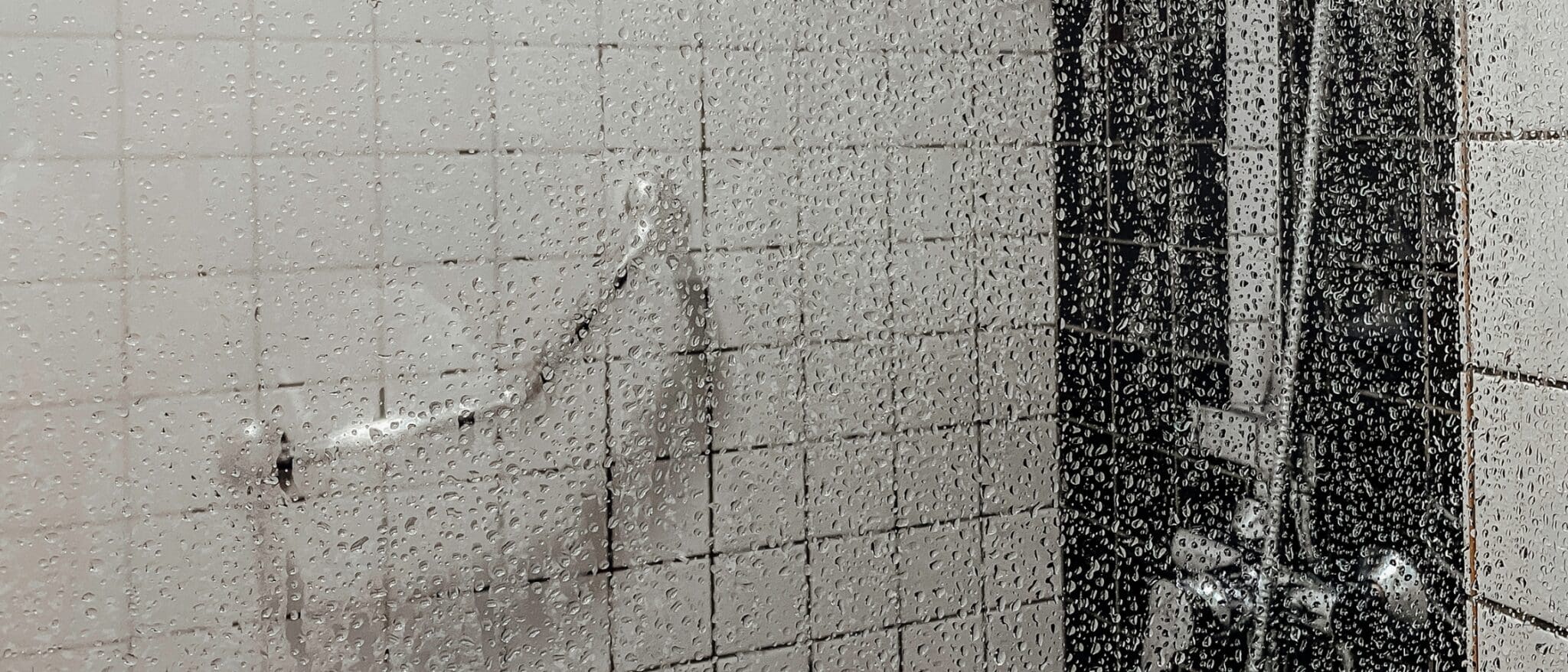 Beslagen douchedeur met waterdruppels
